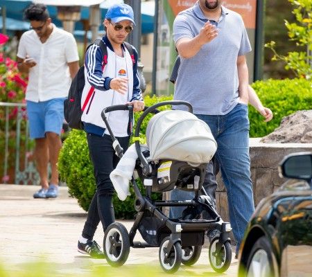 Louis Tomlinson smiles as he takes his son Freddie Reign for an afternoon stroll in Los Angeles, CA